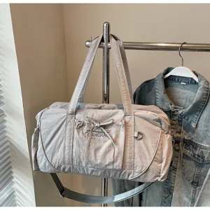 Large capacity grey nylon travel duffel bag with shoulder strap and bow pocket detail