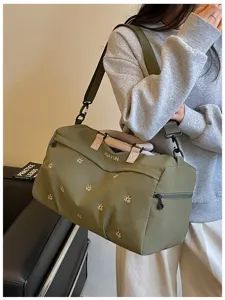 Detail shot of a military green travel duffel bag with shoulder strap for sports and gym.