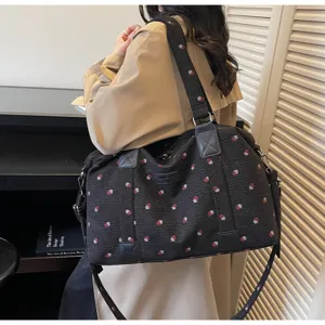 Large capacity travel duffel bag with stylish strawberry pattern and comfortable straps for trips.