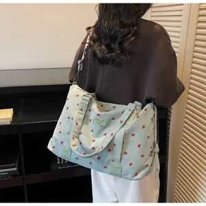 Corduroy travel duffel bag with cute strawberry print large capacity shoulder bag detail.