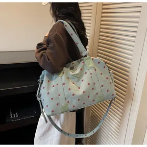 Detailed view of the cute strawberry corduroy travel duffel bag with adjustable strap.