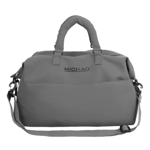 Grey gym duffel bag for women, large capacity travel tote bag with adjustable shoulder strap.