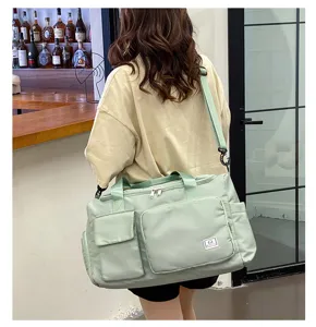 Large capacity gym duffle bag with multiple pockets and adjustable shoulder strap for travel.