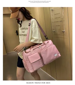 Large capacity pink shoulder duffel bag with multiple pockets, ideal for gym and travel use.