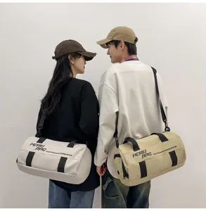 Large capacity cylindrical duffel bag for sports, gym, and short travel with shoulder strap.
