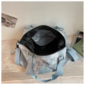 Detailed view of large capacity travel duffel bag interior, pockets and dry storage.