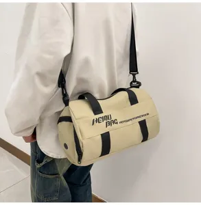 Duffel bag detail showing cylindrical shape, black straps, and casual wear scenario.