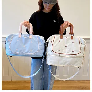Detailed view of the large capacity travel duffel bag showing expandable storage and handles.