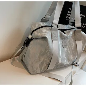 Grey crinkled PU travel duffel bag with handles and strap for gym sports and outdoor trips.