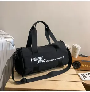 Black cylindrical duffel bag for gym and travel with large capacity and shoulder strap