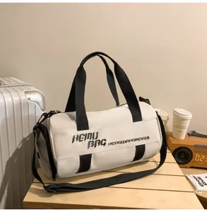 Detailed side view of white cylindrical sports fitness duffel bag with black straps.