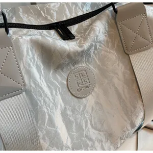 Silver crinkled PU travel duffel gym bag with sturdy webbed handles and zipper closure.