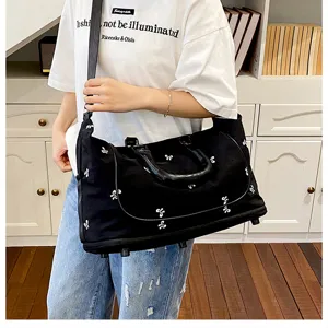 Black canvas travel duffel bag with cute bow embroidery, large capacity gym bag for women.