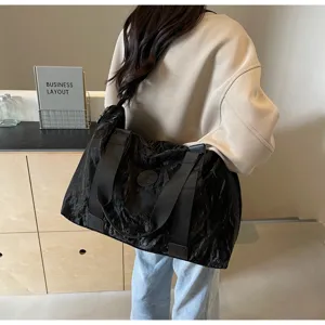 Black crinkled large capacity travel shoulder bag for gym and sports, casual portable design.