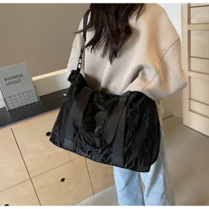 Large capacity black travel duffel bag for gym, sports and outdoor weekend trips with shoulder strap.