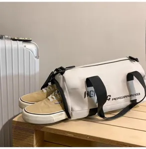 Cylindrical travel duffel bag with shoe compartment, large gym bag for sports and short trips.