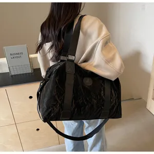 Large capacity black PU travel duffel bag for gym, sports, and casual weekend trips.
