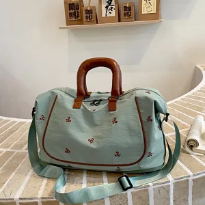 Large capacity travel duffel bag with bow embroidery, green canvas weekend bag for gym.