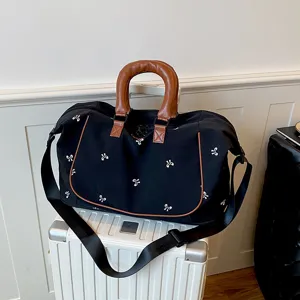Large capacity travel duffel bag with stylish bow print, durable handles and strap for gym.