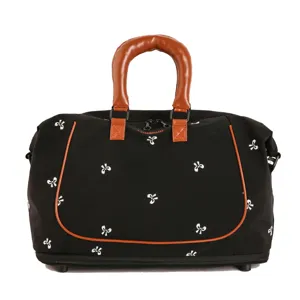 Black travel duffel bag with bow print and brown leather handles for gym and weekend trips.