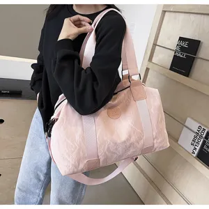 Pink travel duffel bag with wide shoulder strap, stylish gym and yoga bag for women detail view.