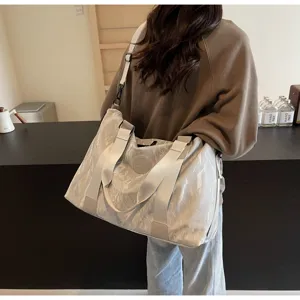 Large capacity travel duffel bag for women, waterproof gym sport tote bag with handles.