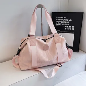 Pink travel duffel bag large capacity sports fitness bag with shoulder strap and handles.