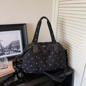 Large capacity travel duffel bag with cute strawberry print, durable fabric shoulder bag.