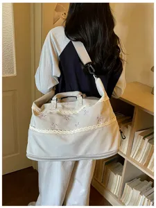 Detailed view of the large capacity travel duffel bag with cute bows and lace trim.