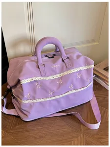 Purple travel duffel bag with cute lace trim and embroidered bows for gym and weekend trips.