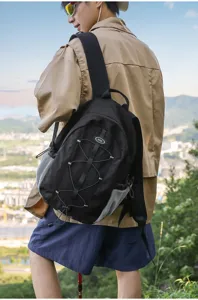 Outdoor black backpack detail view showcasing large capacity and adjustable elastic cords.