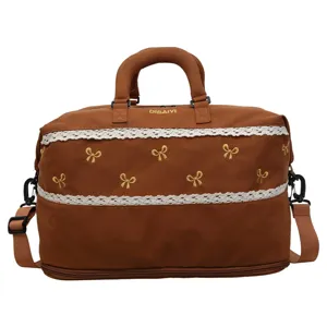 Brown travel duffel bag with cute embroidered bows and white lace trim for gym and travel.