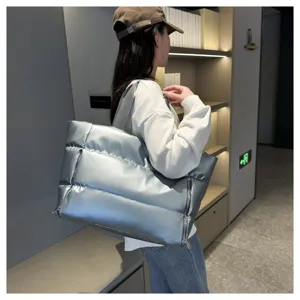 Stylish silver puffer tote bag with large capacity, soft padded shoulder bag for women.