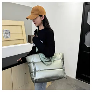Large puffer gym bag for women, stylish silver quilted shoulder tote and travel duffel bag.