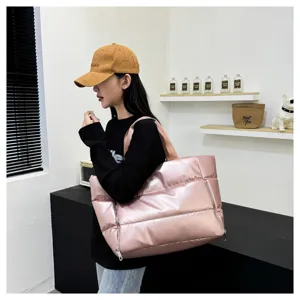 Pink quilted puffer tote bag for women, stylish padded shoulder bag for gym and travel.