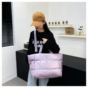 Large capacity puffer tote bag for women, waterproof fitness gym bag and stylish travel duffel.