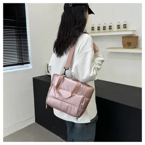 Details of pink quilted gym bag, waterproof travel handbag with shoulder strap for women.
