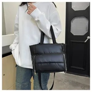 Black quilted tote bag with front zip pockets, versatile waterproof fitness and travel shoulder bag.