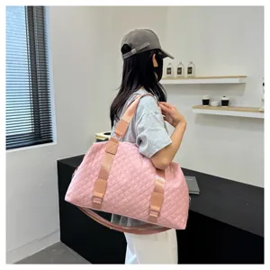 Pink quilted gym bag detail view, showcasing durable fabric, wide strap and large capacity.