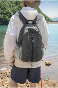 Outdoor backpack worn by model in nature setting, highlighting capacity and straps.