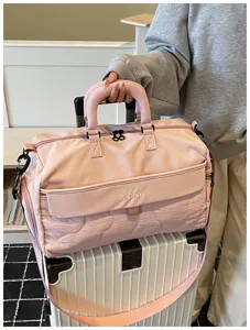 Large capacity pink travel duffel bag with shoulder strap, perfect for fitness and short trips.