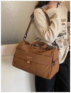 Large capacity travel duffel bag for women, waterproof gym tote bag for short trips storage.