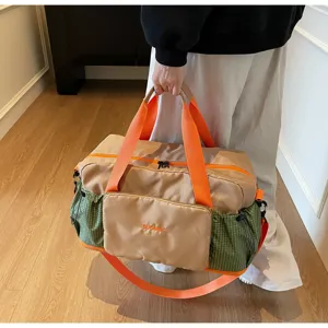 Stylish travel duffel bag with gym storage, wet dry separation and bold orange straps.