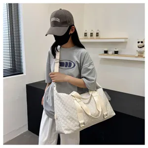 Large capacity quilted duffel bag for women, waterproof fitness travel bag with shoulder strap.