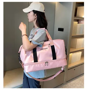 Large capacity pink travel duffel bag with wet dry separation and shoulder strap detail view