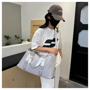 Grey quilted travel duffel bag with large capacity, waterproof fitness gym bag for women.