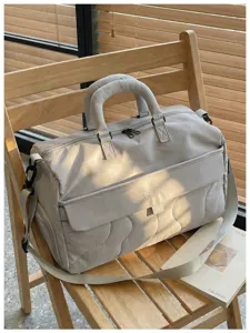Detailed view of the large capacity travel duffel bag, showing water-repellent fabric and dual handles.