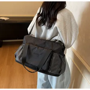 Stylish large capacity travel duffel bag with plaid side pockets and comfortable straps.