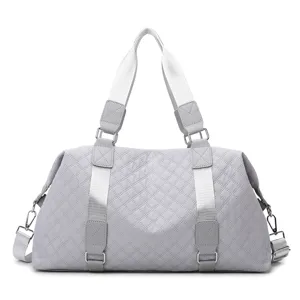 Light gray quilted duffel bag, large capacity fitness gym bag for women travel and yoga use.