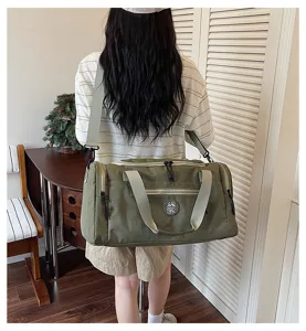 Detailed view of the army green travel duffel bag worn on shoulder, showing capacity and style.